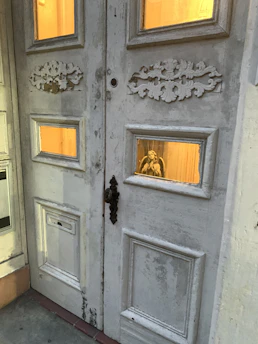 A serene old wooden door with a heart-shaped carving, symbolizing faith and home.