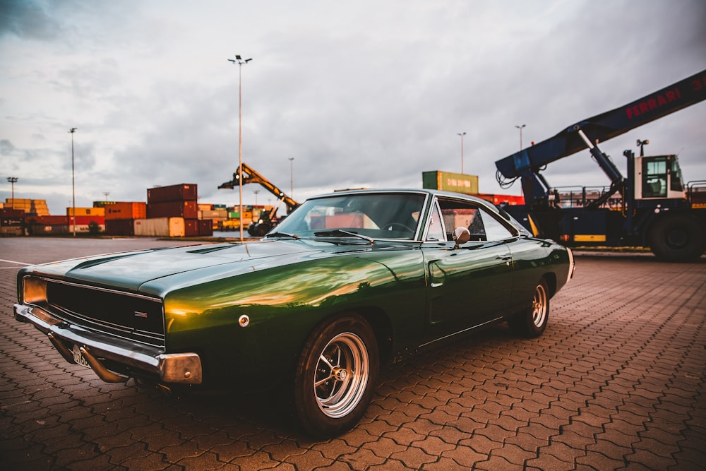 green chevrolet camaro parked on parking lot during daytime