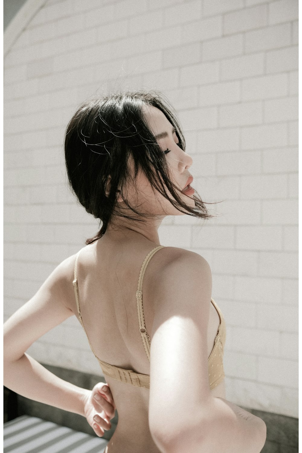 woman in white brassiere with black hair