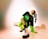 boy in black and green t-shirt and black pants sitting on floor