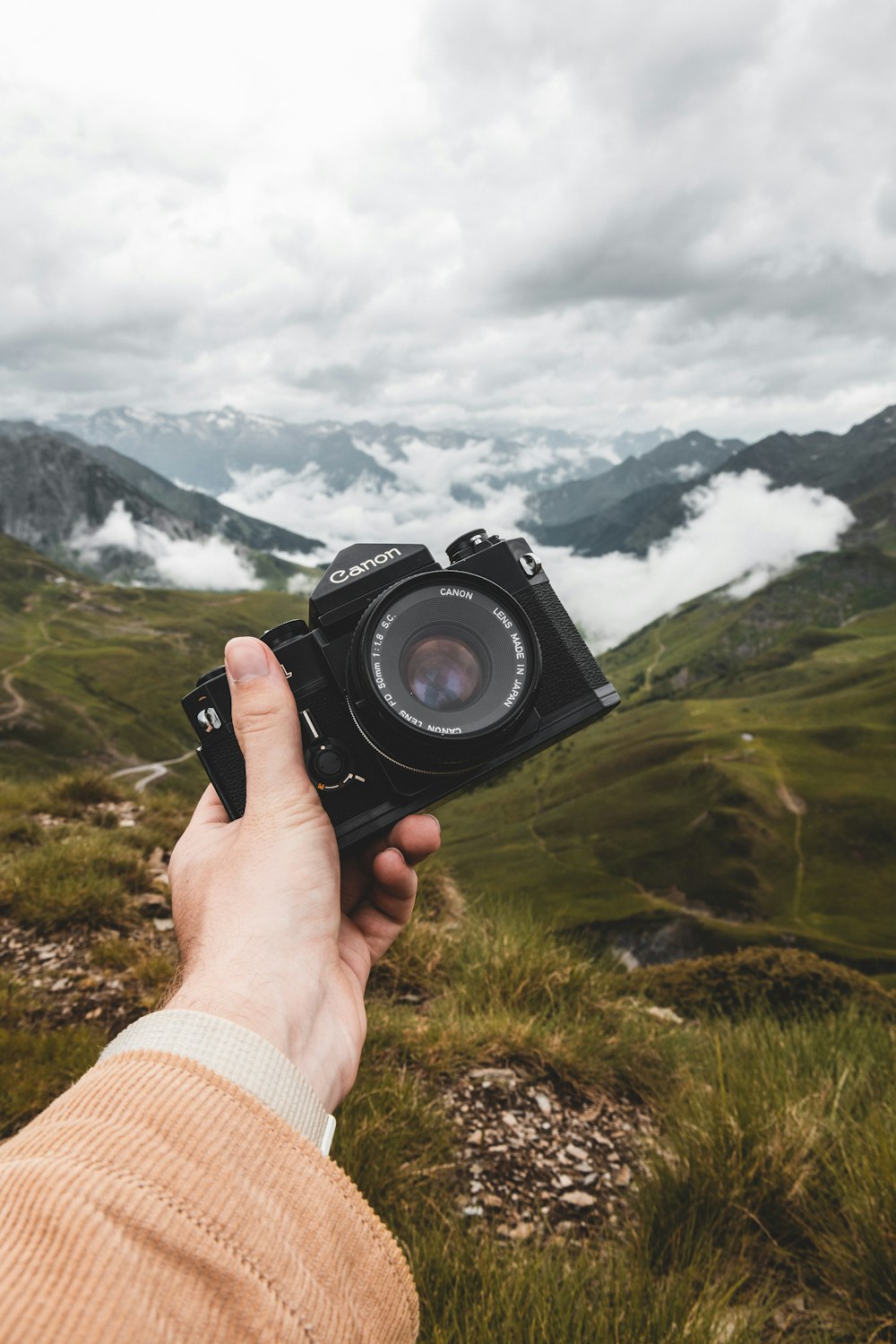 person holding black nikon dslr camera