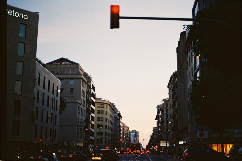 cars on road between high rise buildings during daytime