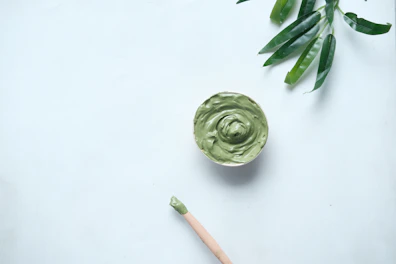 green ceramic round bowl on white table