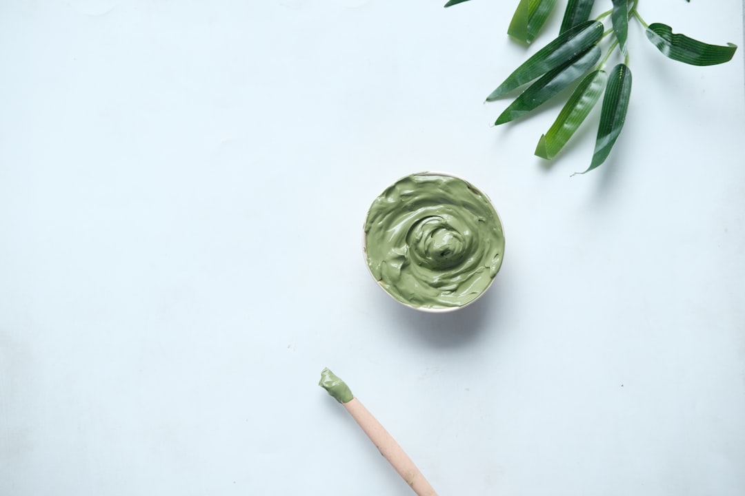 green ceramic round bowl on white table,
