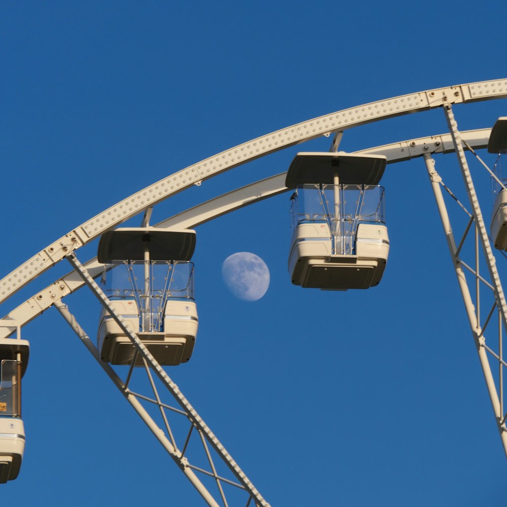 white and black ferris wheel under blue sky during daytime