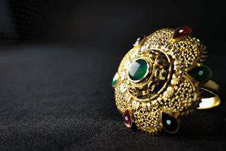 gold and blue ring on black textile