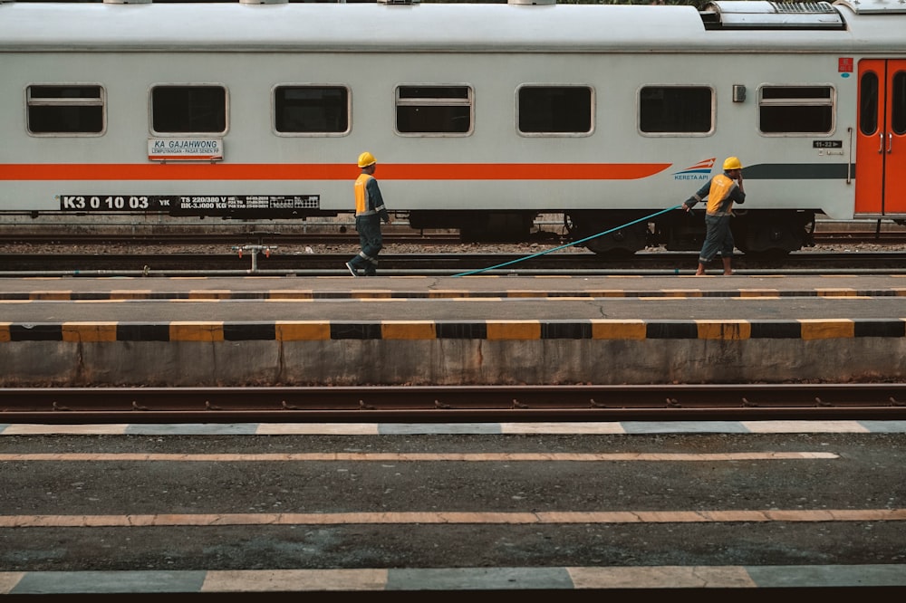 white red and blue train on rail track