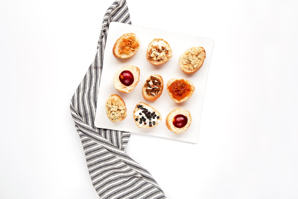 brown and white doughnuts on white ceramic plate