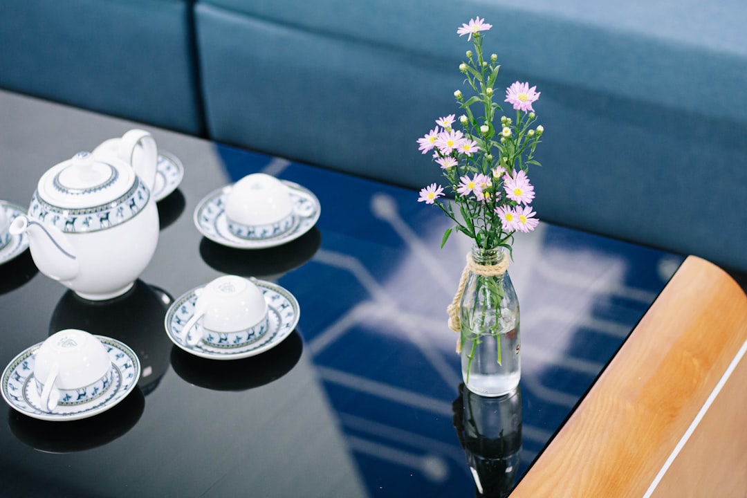 white and blue flowers in clear glass vase