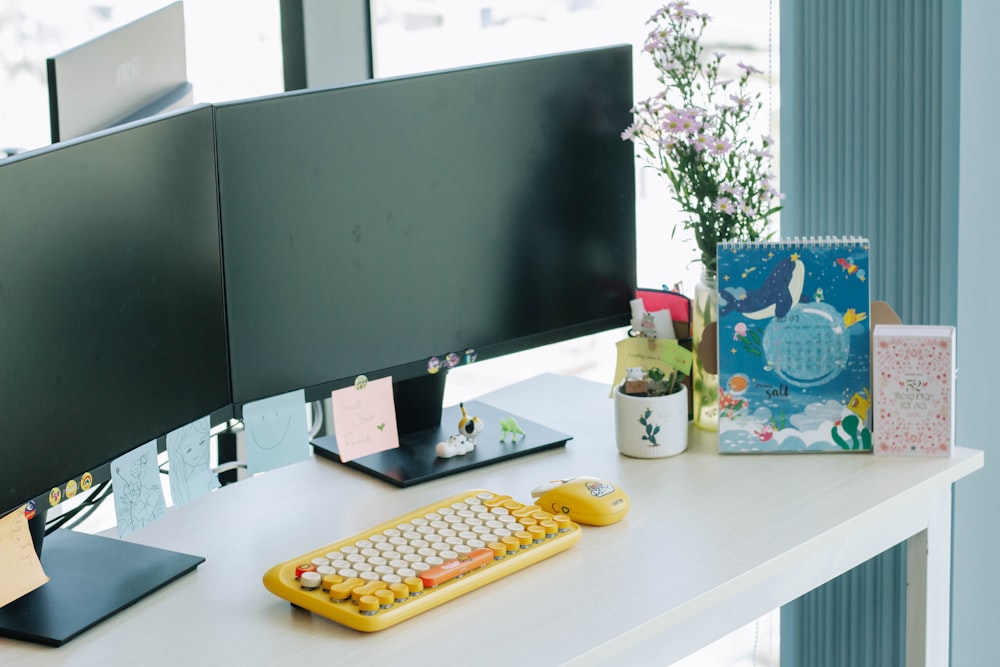 black flat screen computer monitor on white desk