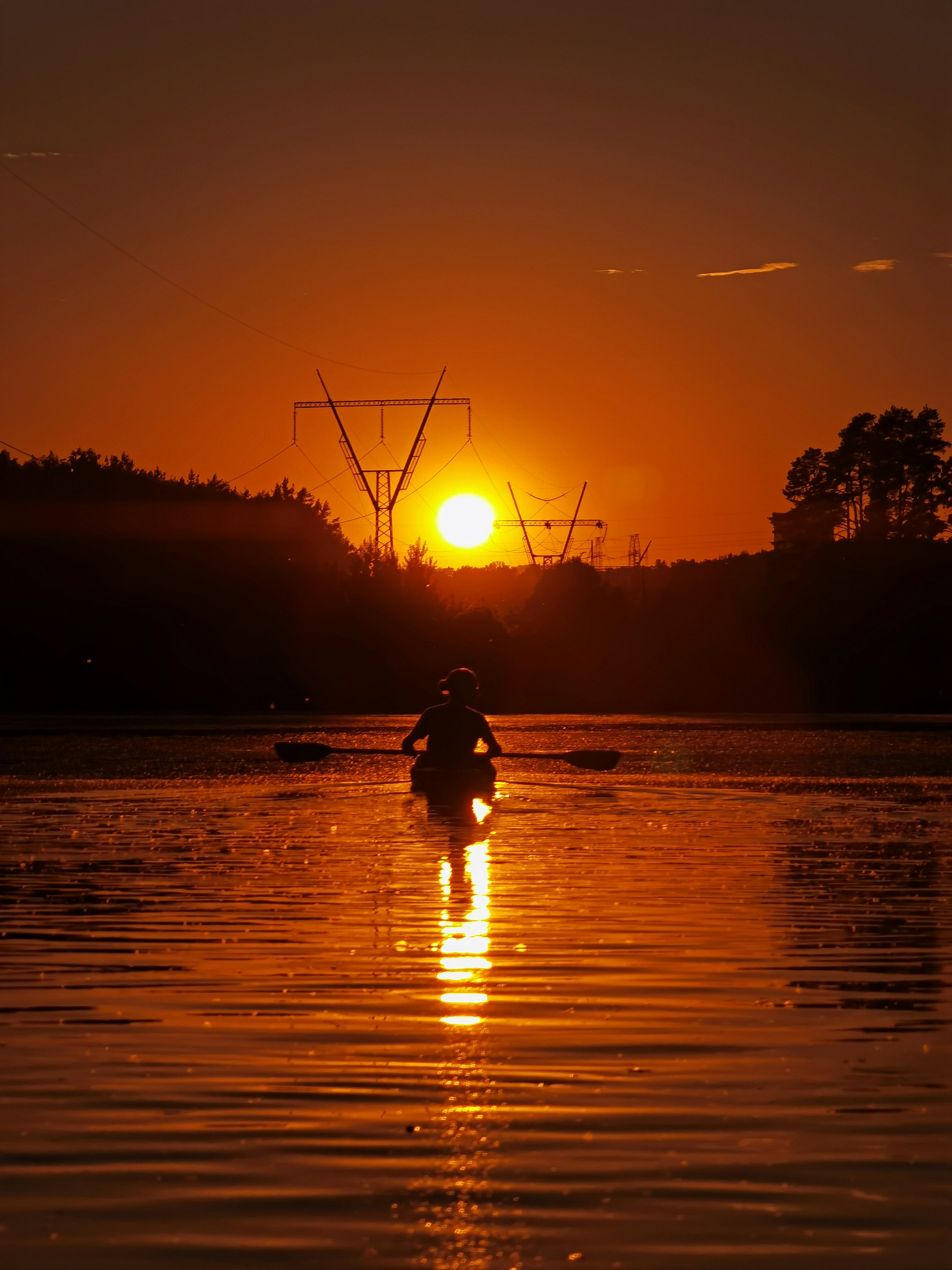 silhouette of person riding on horse on water during sunset