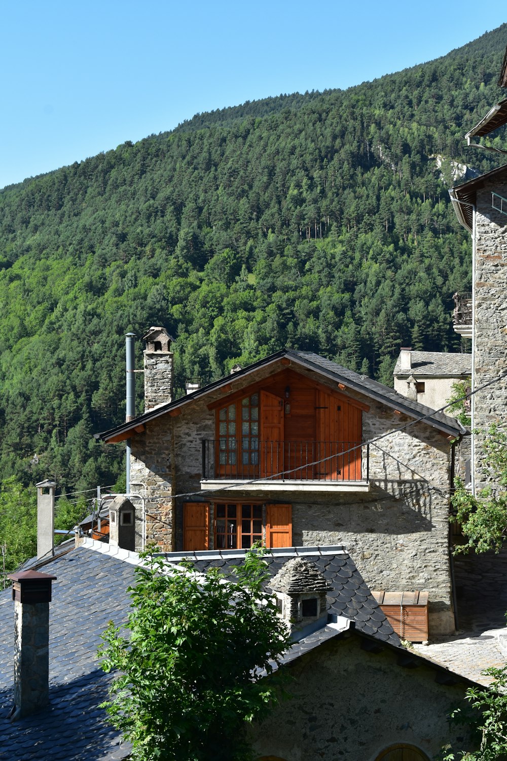 brown and white concrete house near green trees during daytime