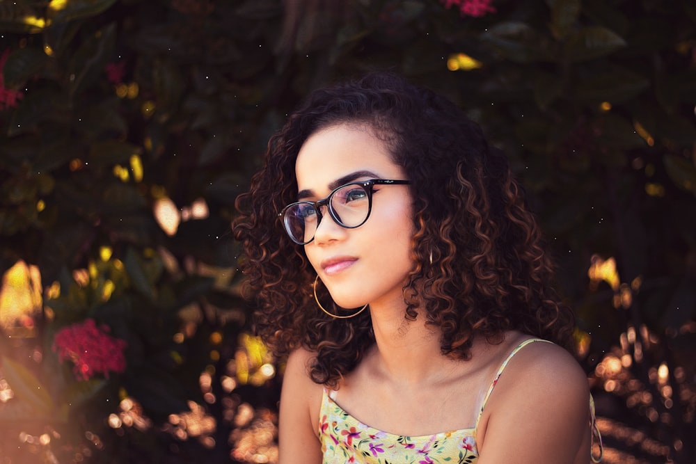 woman in white and green tank top wearing black framed eyeglasses