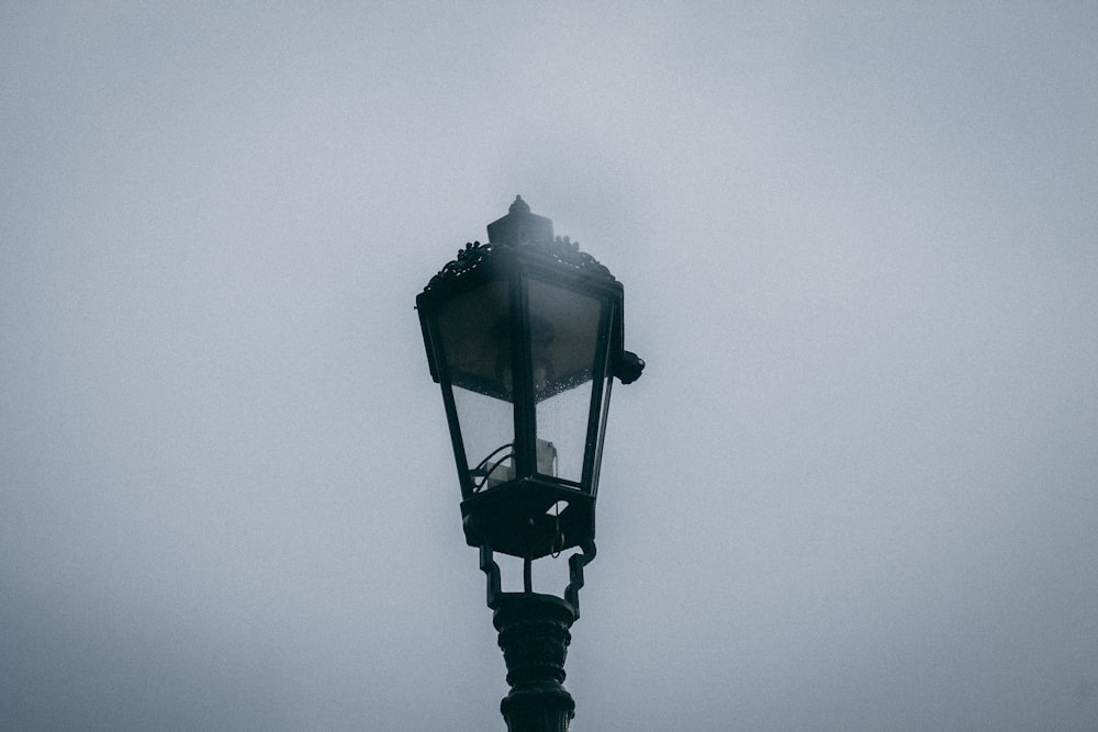 black street lamp under gray sky