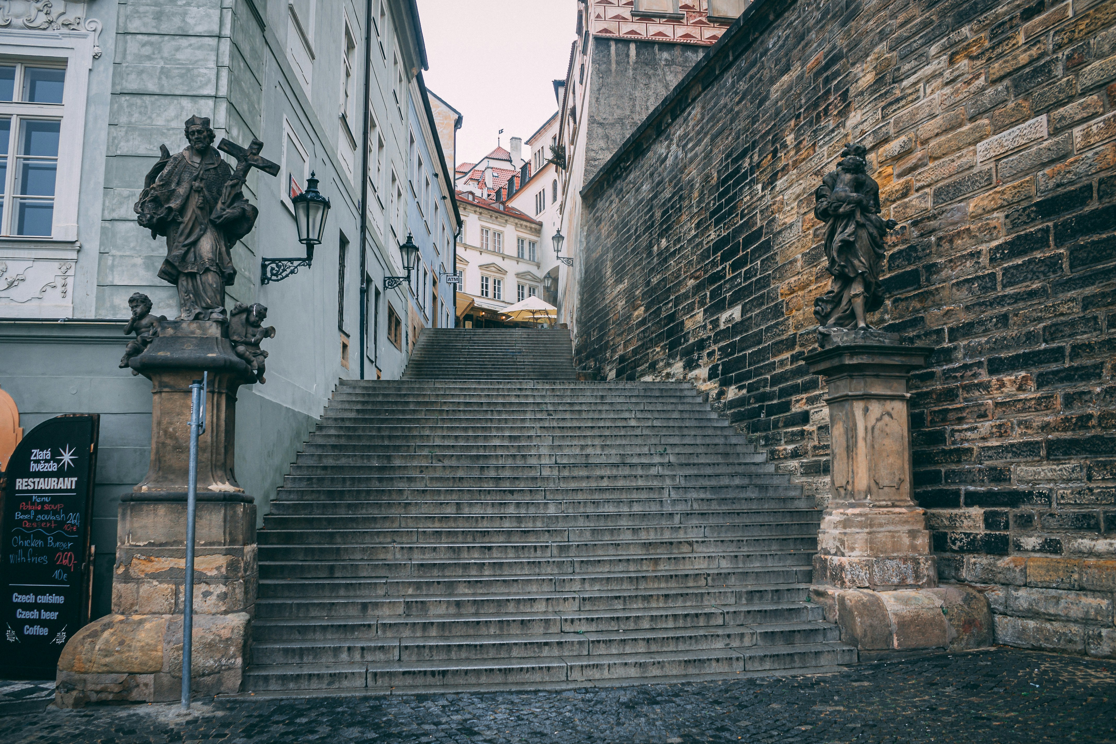 gray concrete stairs with statues
