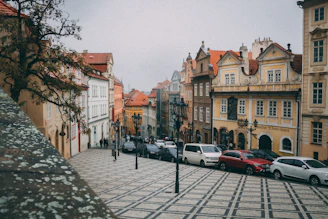 A charming cobblestone street in a historic European town with colorful buildings.