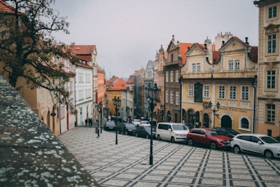 A charming cobblestone street in a historic European town lined with colorful buildings.