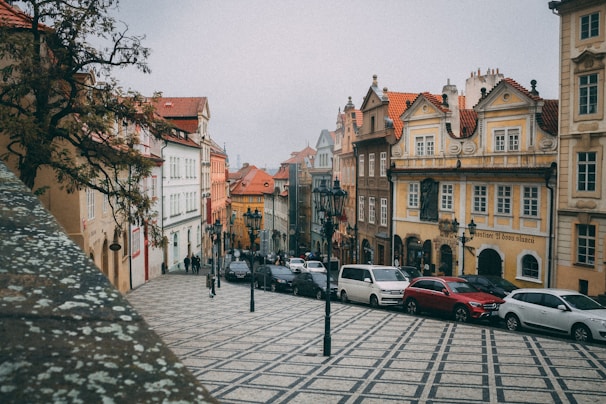 A charming street in a European town with colorful buildings and cobblestone paths.