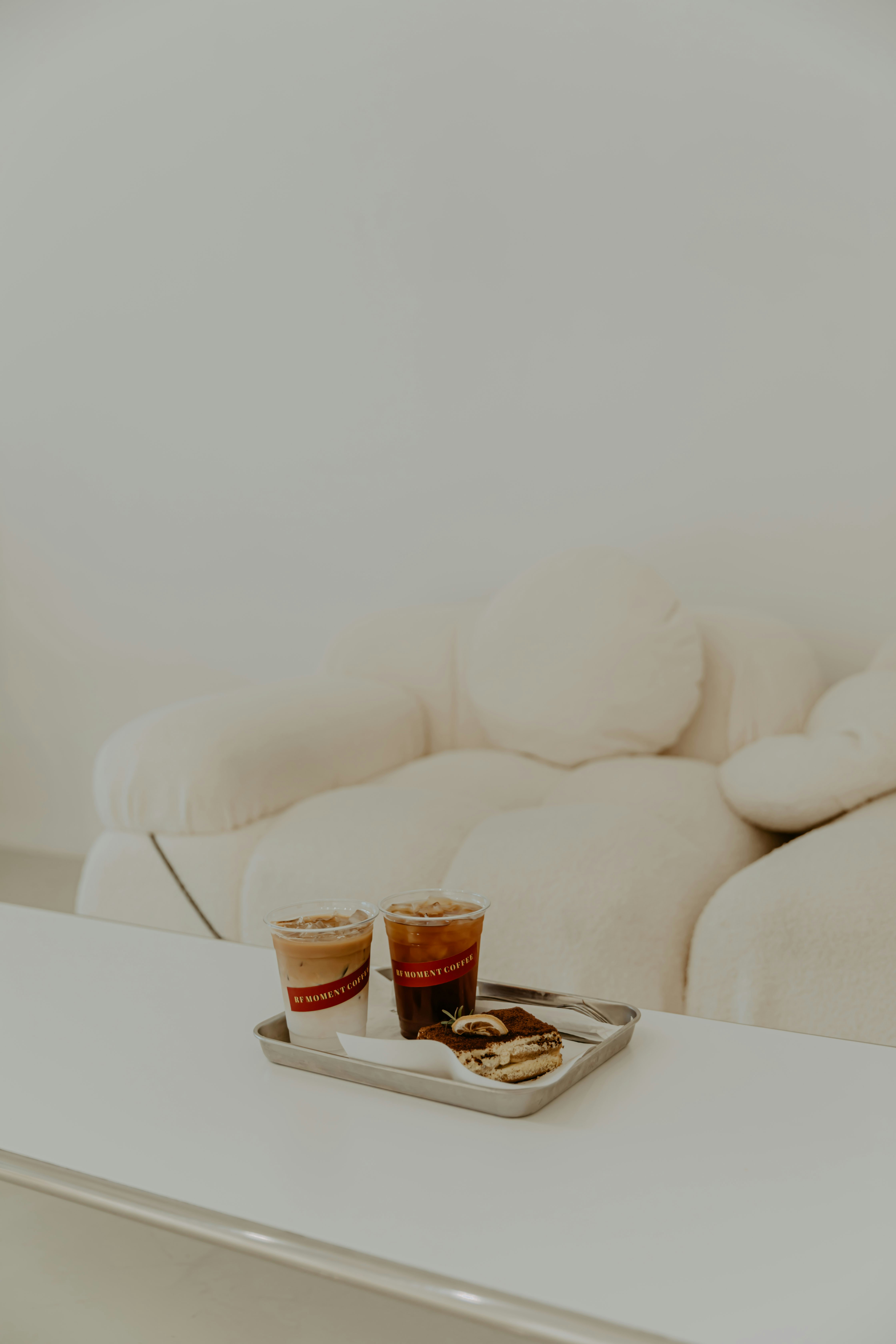 white sofa chair with coffee mug on table