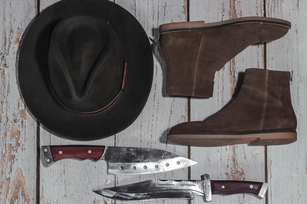 brown cowboy hat beside silver and red folding knife