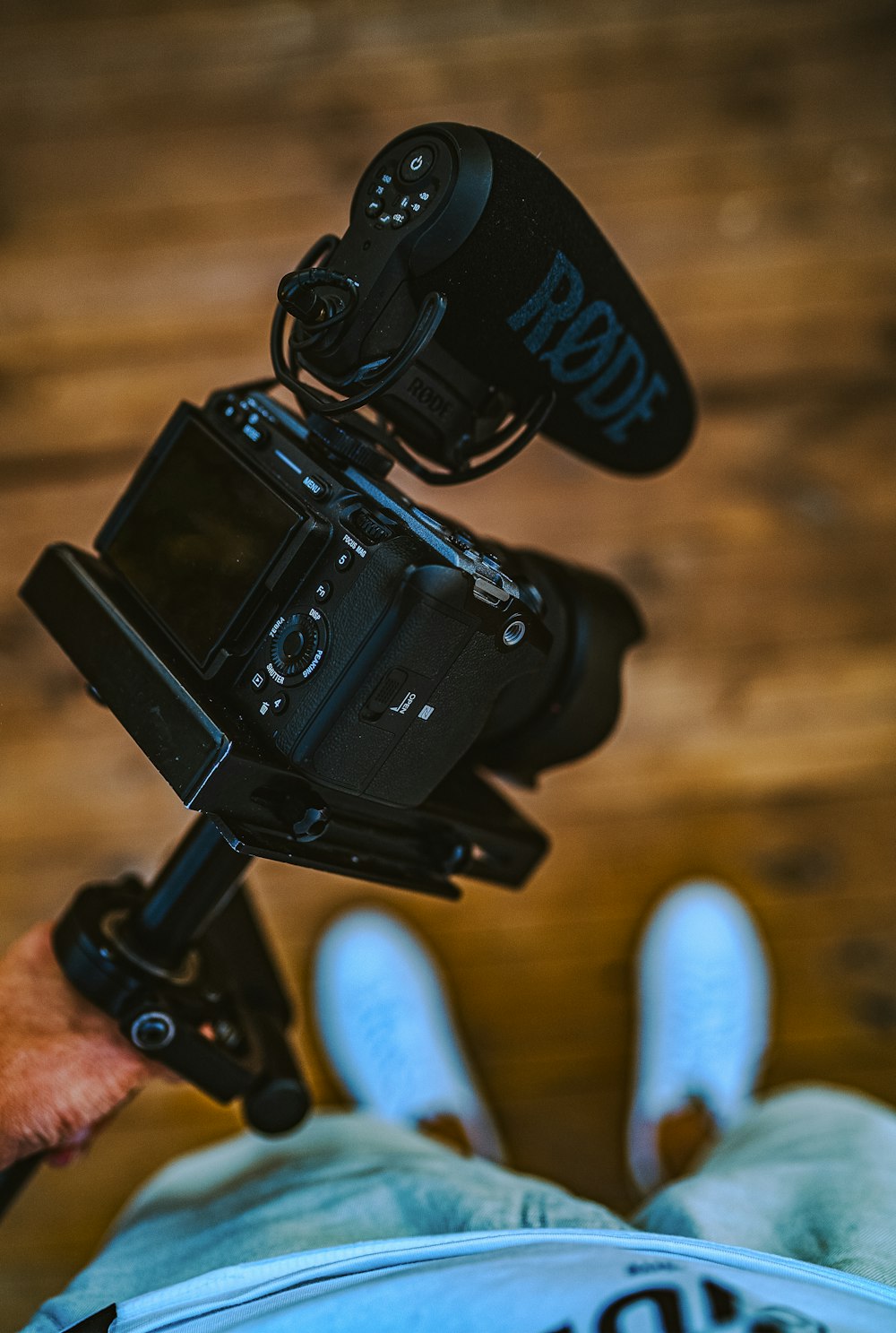 black dslr camera on brown wooden table