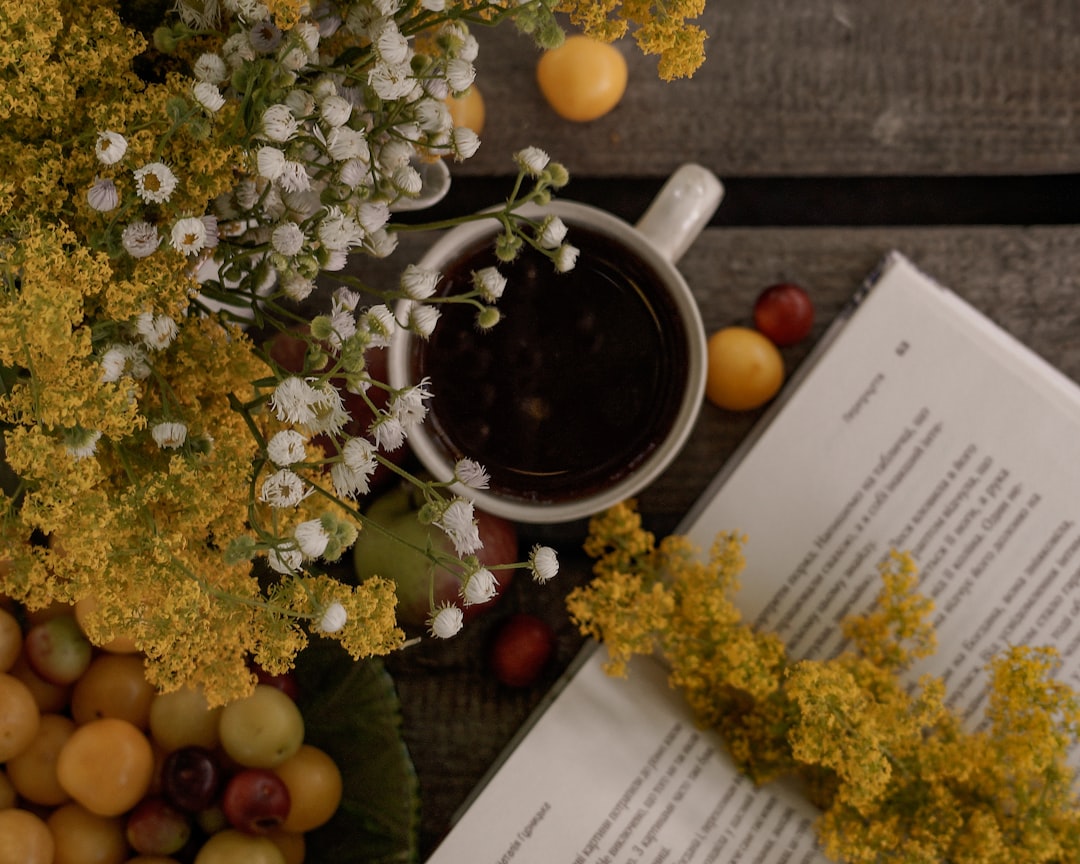 white and yellow flowers on white ceramic mug