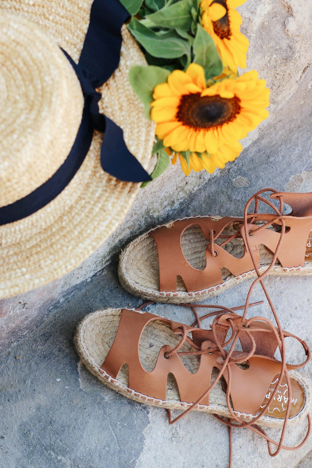 brown and black sandals on gray concrete floor