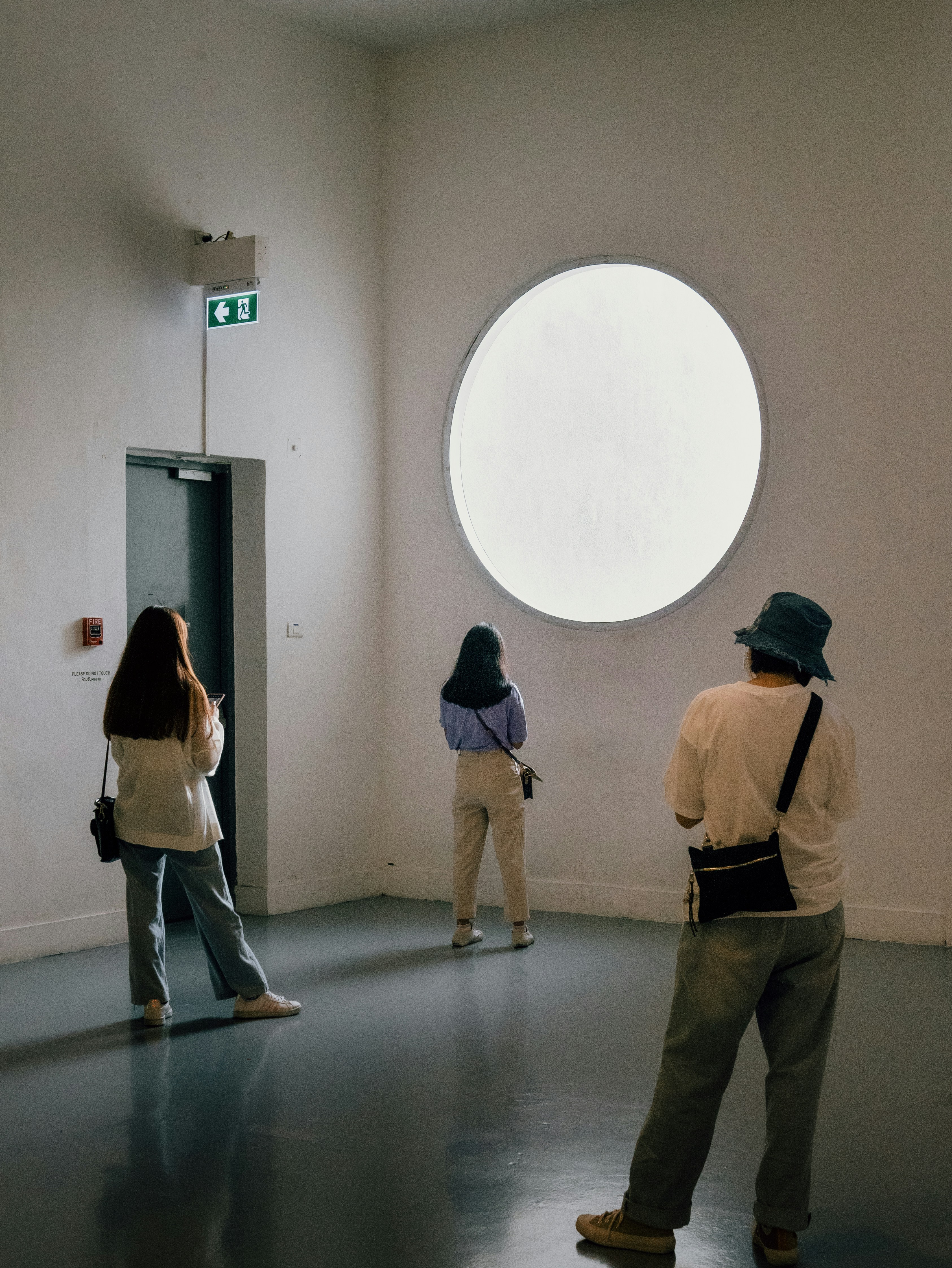 2 women standing in front of white wall