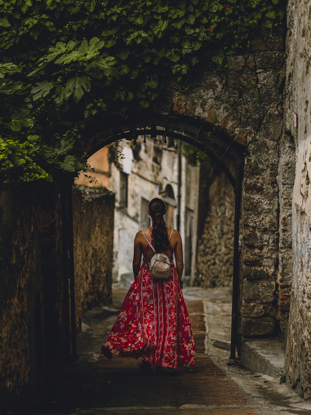 woman in red dress standing on hallway