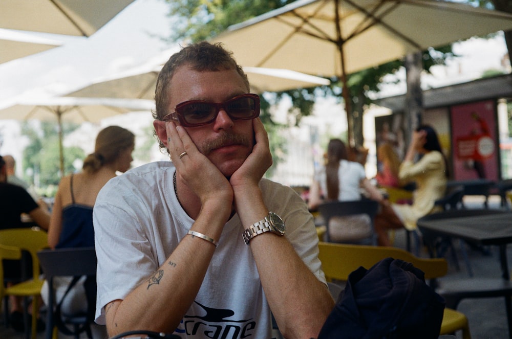 man in gray crew neck t-shirt wearing black sunglasses