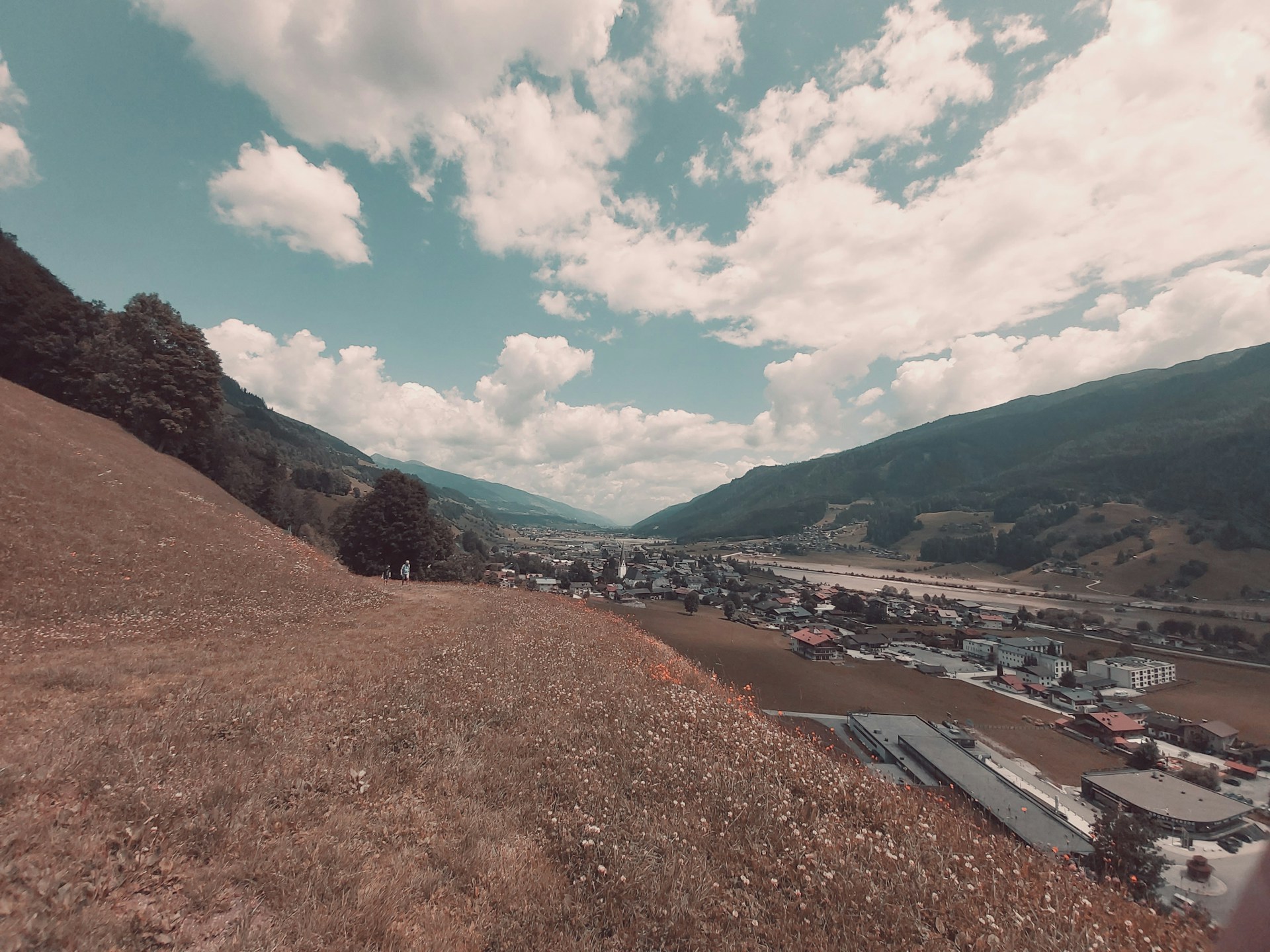 woman wearing yellow long-sleeved dress under white clouds and blue sky during daytime