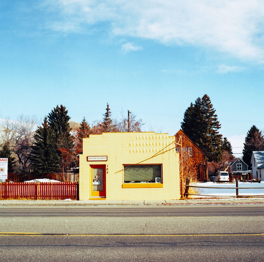 white and brown concrete building near trees under blue sky during daytime