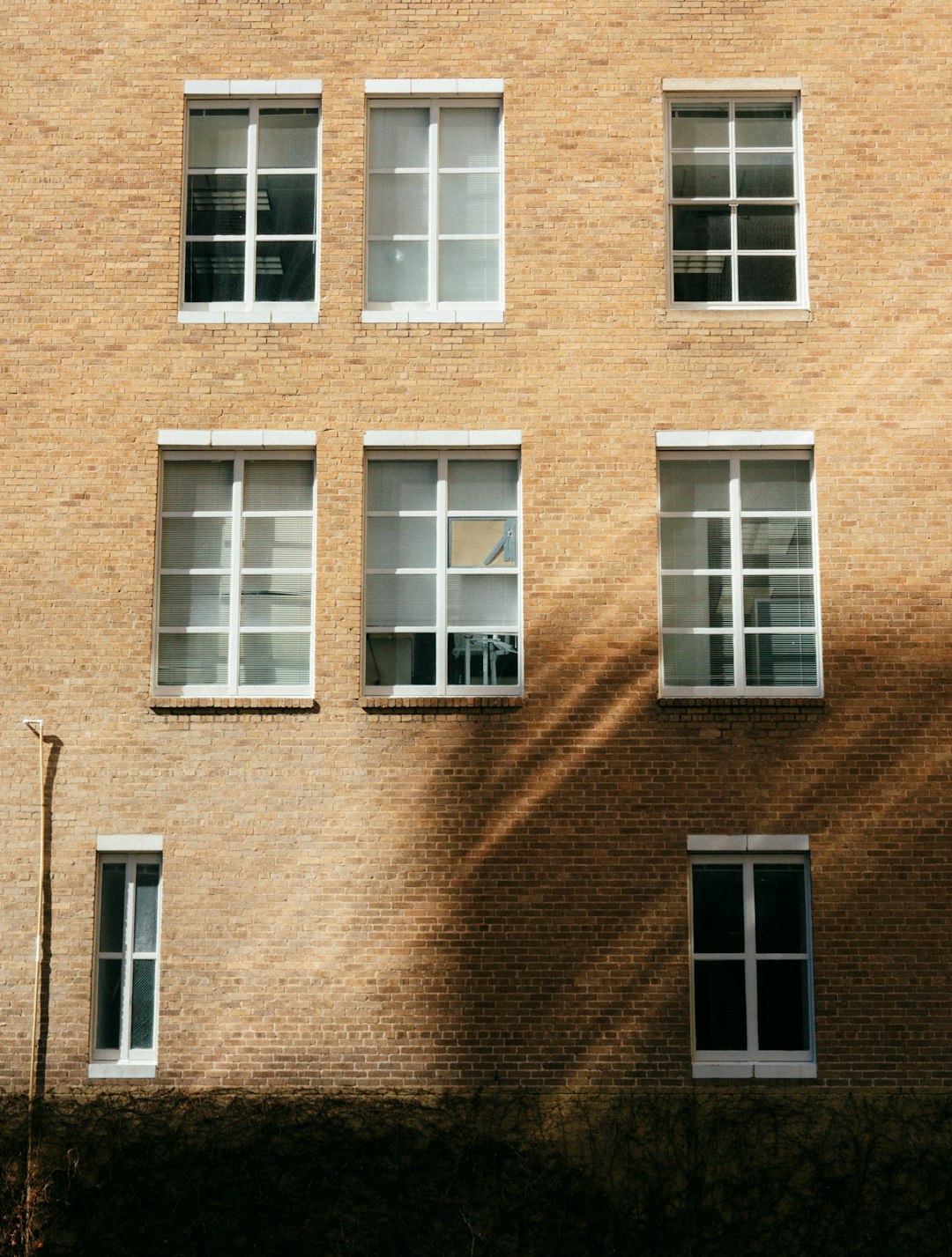 brown brick building with white window frame