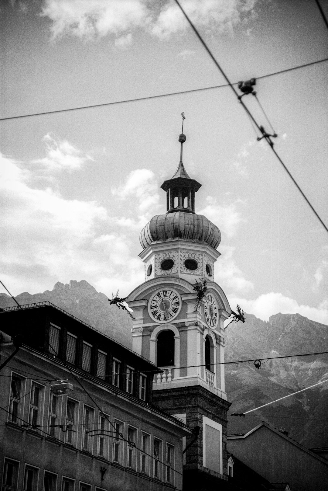 grayscale photo of concrete building with tower clock