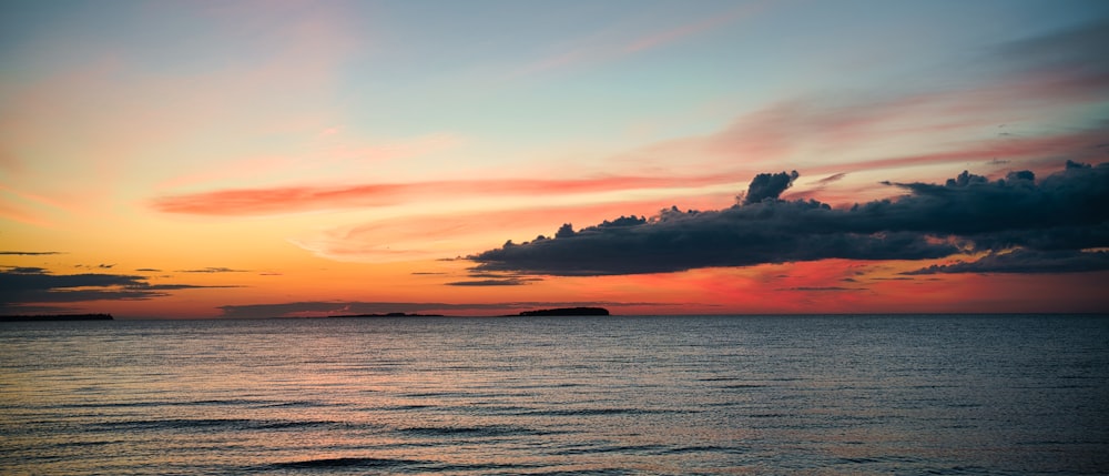 body of water during sunset