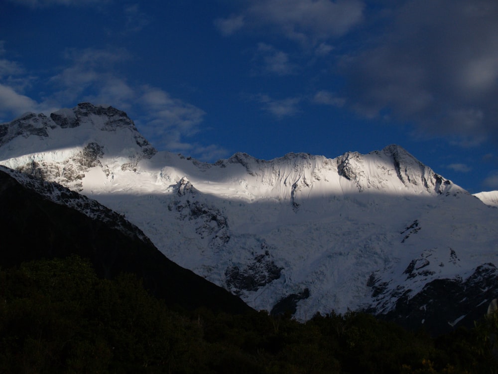 snow covered mountain under blue sky during daytime