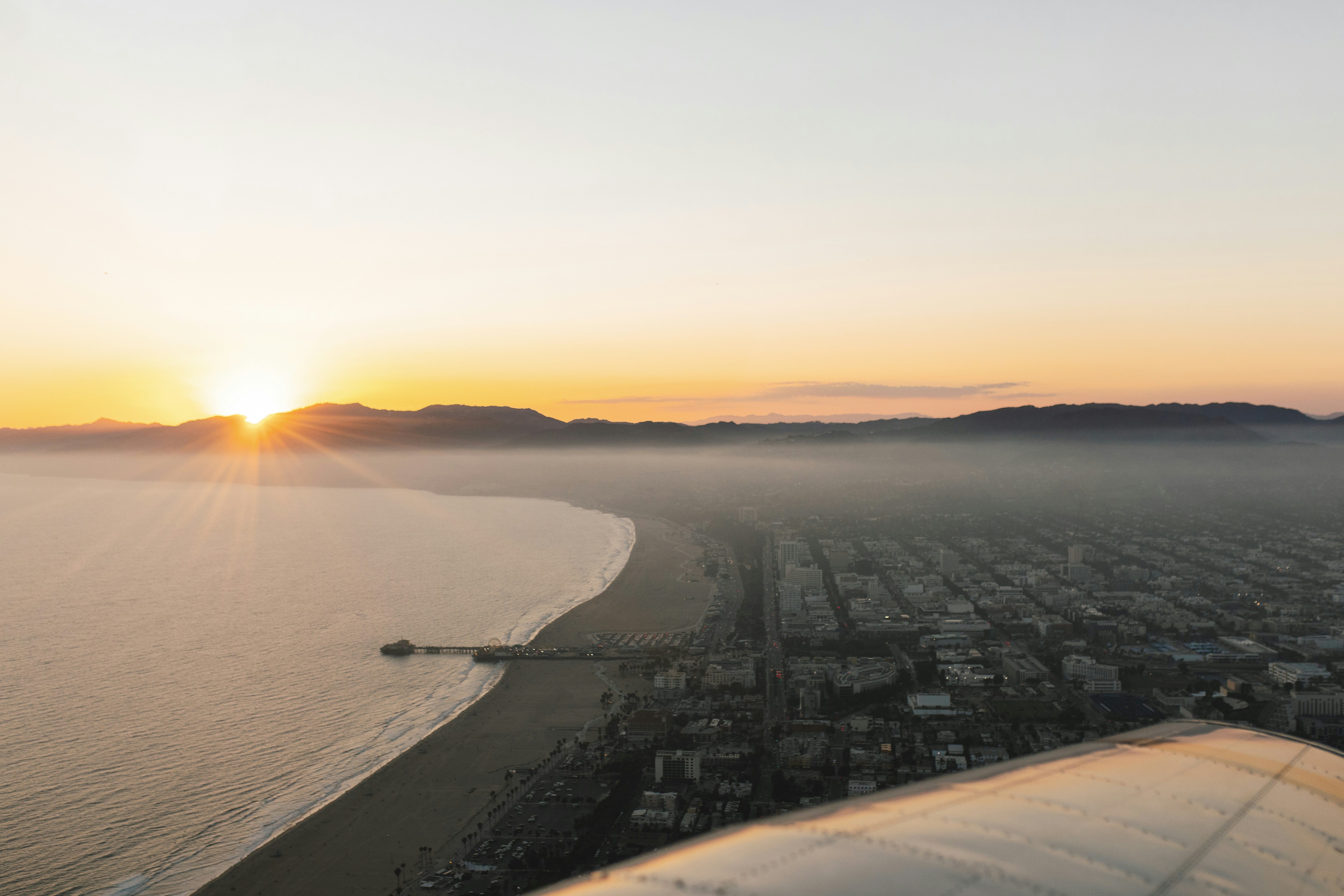 city buildings near sea during sunset