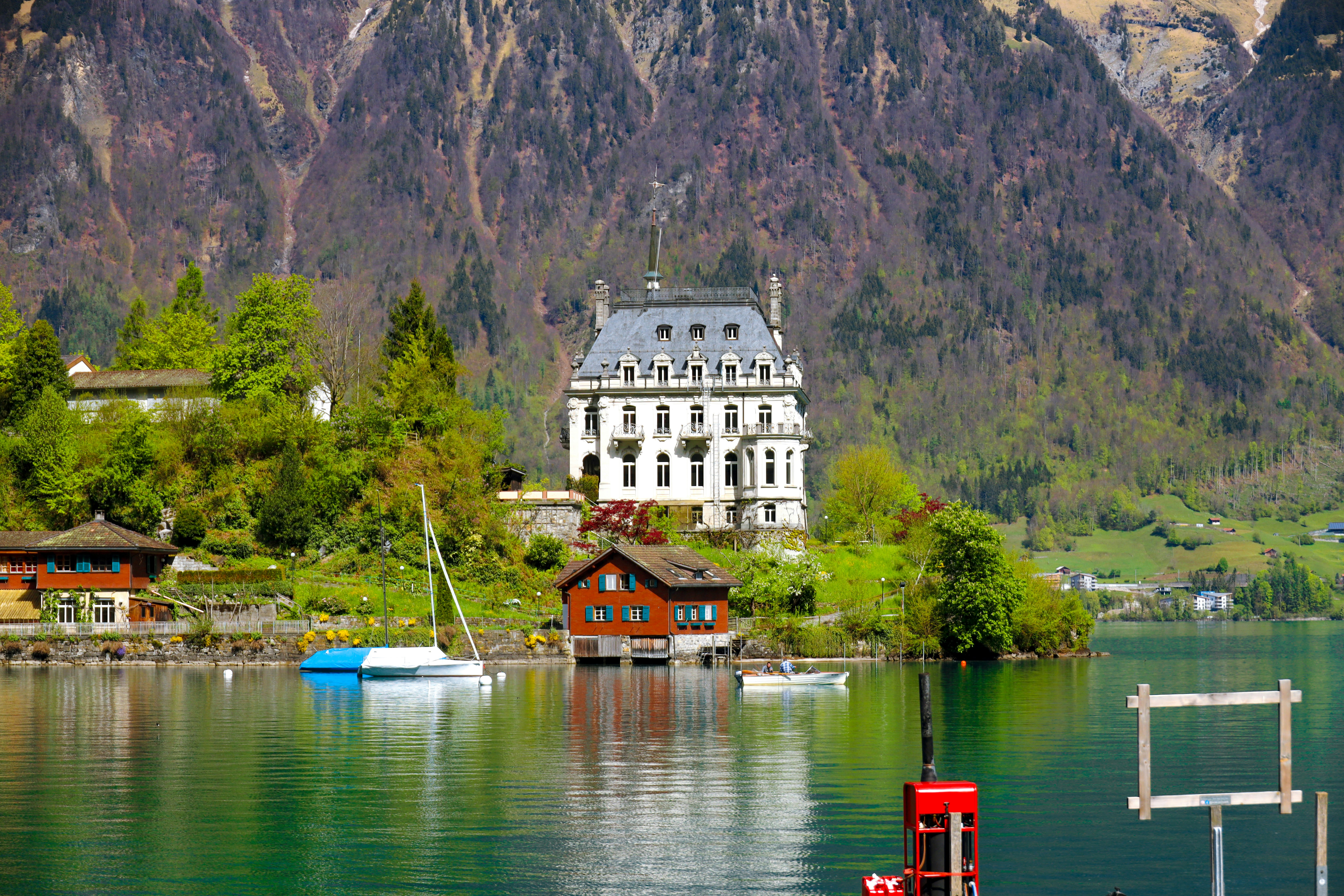 white and brown concrete building near body of water during daytime