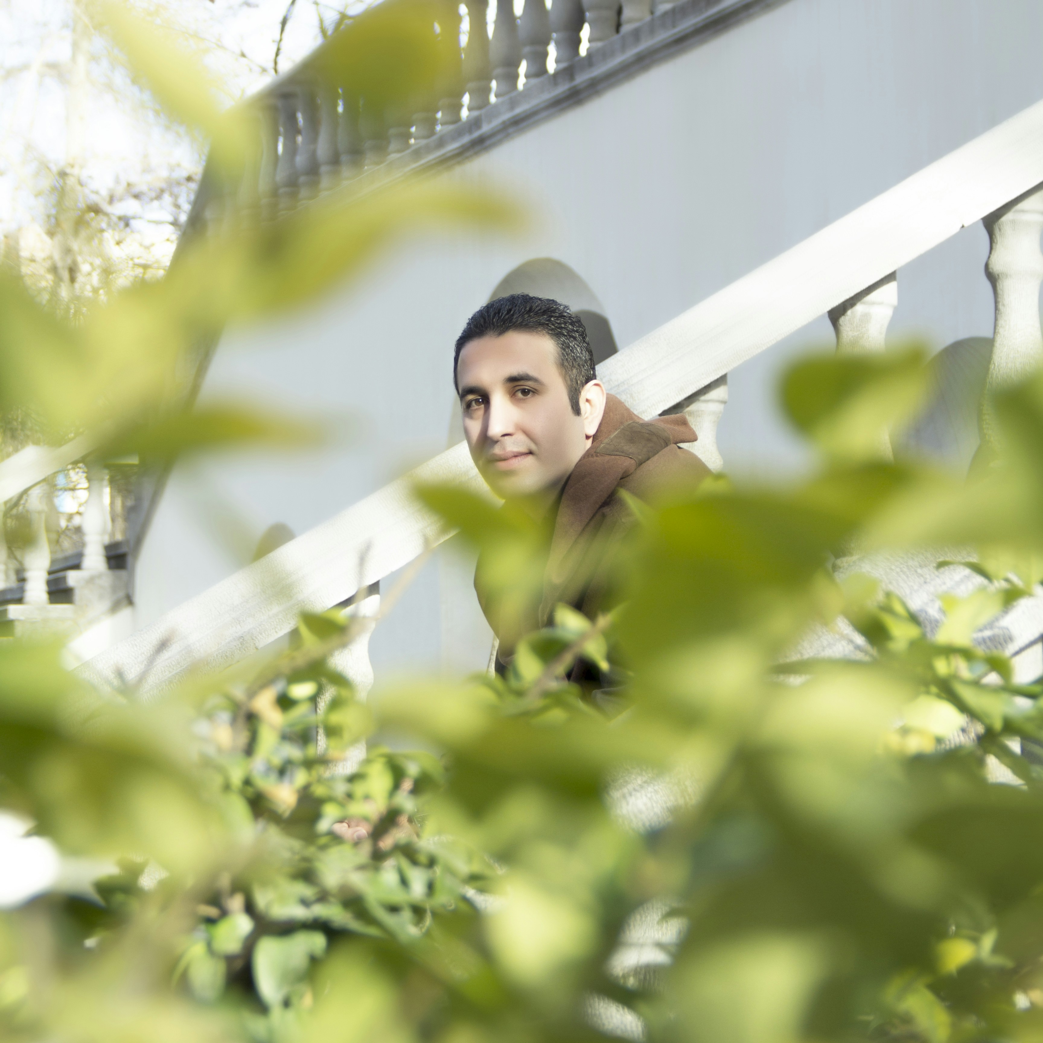 man balcony plants portrait