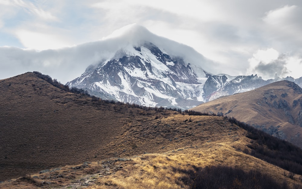 snow covered mountain under cloudy sky during daytime