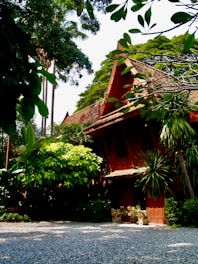 red and brown concrete building near green trees during daytime