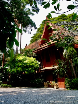 red and brown concrete building near green trees during daytime