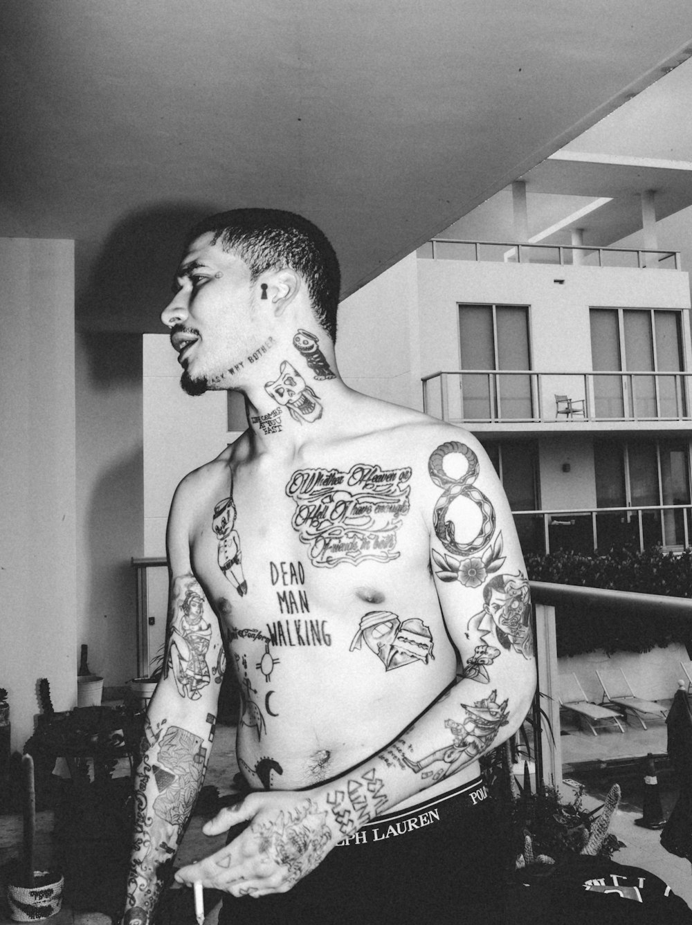 topless man with tattoo on his body