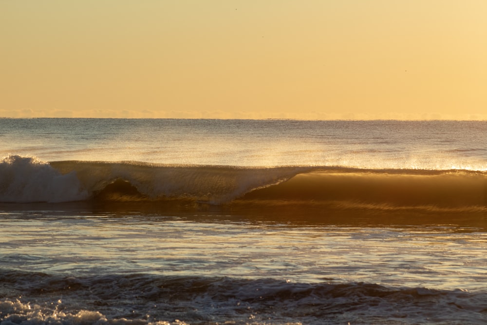 ocean waves crashing on shore during daytime