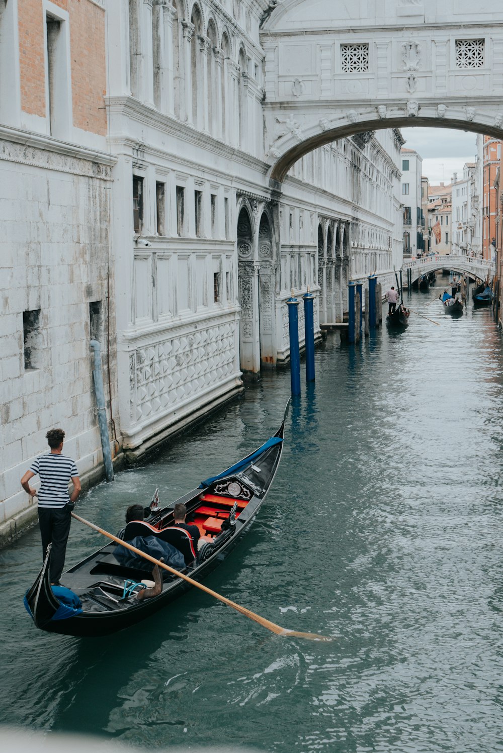 man in black boat on river during daytime