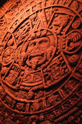 Close-up of a colorful Mayan calendar glyph with intricate details.