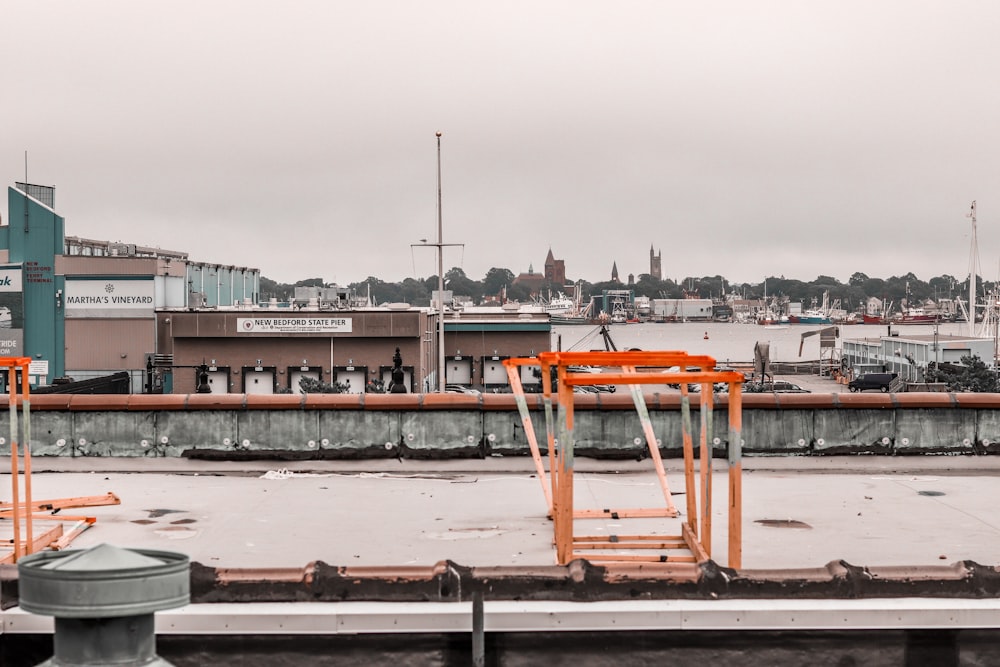 orange metal crane on dock during daytime