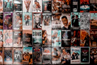 A wall covered with a grid of vintage VHS movie cassette covers