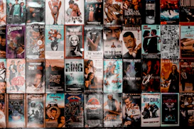 A wall covered with a grid of vintage VHS movie cassette covers