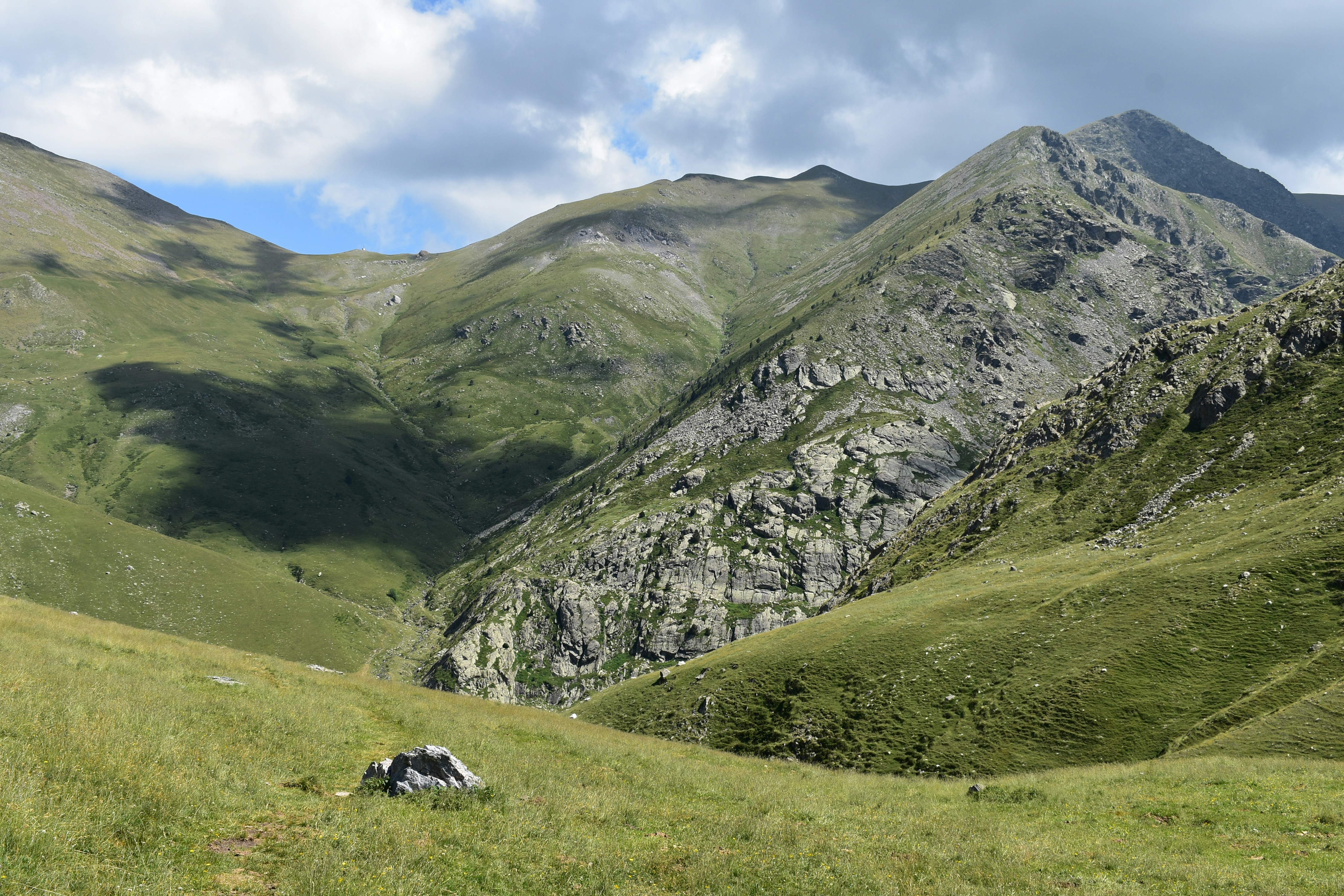 green grass field and mountain during daytime